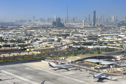 United Arab Emirates, Dubai, Dubai International Airport and the city center in the background (aerial view)