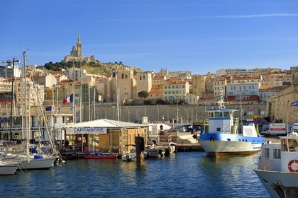France, Bouches du Rhone, Marseille, the Harbor Master's office in the Vieux Port, Saint Victor Abbey and the Notre Dame de La Garde basilica in the background