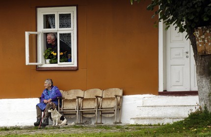 Poland, Sub-Carpathia, couple of senior citizens and their dog at Mrzyglod in the north of Sanok