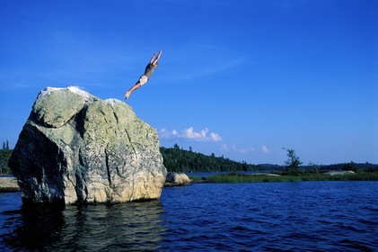 Canada, Quebec Province, La Verendrye Wildlife Reserve, Lake Victoria, dive of a rock overhanging the lake