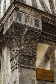 France, Yonne, Auxerre, carved corner post (late 15th century) at the corner of rue Fécauderie and rue Joubert on a half-timbered house