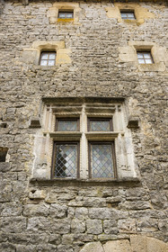 France, Aveyron, Grands Causses regional natural park, the Cistercian fort of Saint-Jean-d’Alcas, the Grenier de la Rente house was once used to store the royalties of the Abbess of Nonenque, Renaissance casement window on the facade of medieval house typical of Caussenarde architecture