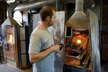 France, Moselle, Meisenthal, glassblower at the Centre international d'Art verrier (CIAV) (international glass centre), recovery of hot glass in a furnace by a glassblower