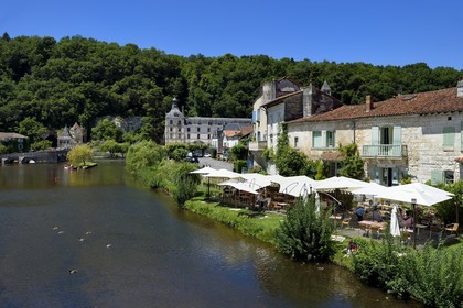 France, Dordogne, Brantome, restaurant terraces along the Dronne river and Saint Pierre benedictine abbey in the background