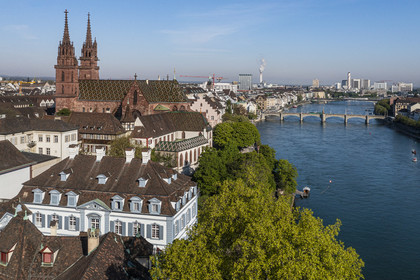 Switzerland, Basel, the left bank of the Rhine, the Minster or Protestant Cathedral of Our Lady of Basel (Munster) overlooking the Rhine, the Mittlere Brucke bridge in the background (aerial view)
