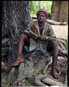 Burkina Faso, Poni province, Lobi land, Loropéni region, Lakar, young lobi flautist in Lakar, the flute, mainly the bamboo flute, is one of the most sacred instruments and is often used during ceremonies such as initiations or funerals