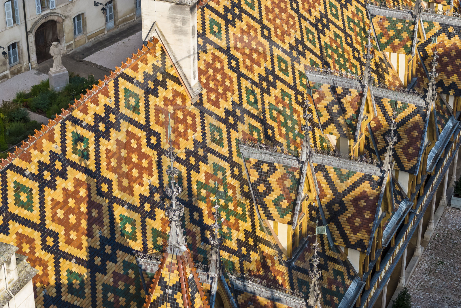 France, Cote d'Or, Beaune, area listed as World Heritage by UNESCO, Hospices de Beaune, Hotel Dieu, the roofs covered with glazed and colored tiles (aerial view)