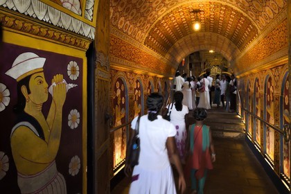 Sri Lanka, center province, Kandy, Temple of the Buddha Tooth (Sri Dalada Maligawa), entry hall decorated with floral motifs and people bringing offerings