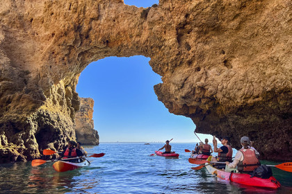 Portugal, Algarve, Lagos, Kayak tour at the foot of the steep cliffs of Ponta da Piedade