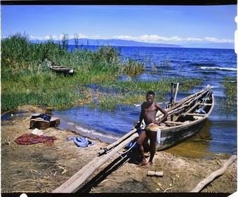 Burundi, Rumonge Province, young Hutu fisherman on Lake Tanganyika, fishermen are exclusively Hutu and come down from the  hills to settle in temporary huts for at least 6 months, fishing is generally done at night with lampara and it's mainly ndagalas (fried fish) mukekes and Lates niloticus, in the background we perceives the tip of Burton and Speke located in the Congo (4x5 reversal film reproduction)