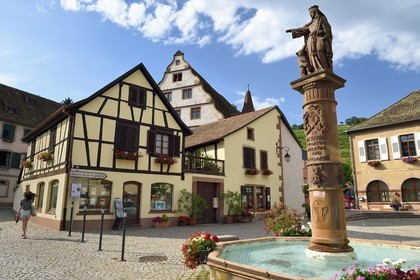 France, Bas Rhin, the Alsace Wine Route, Andlau, sandstone statue of St. Richarde and goddess bear on the fountain of the 19th century