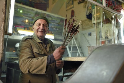 Iran, Isfahan Province, Isfahan, liver skewers seller in the bazaar