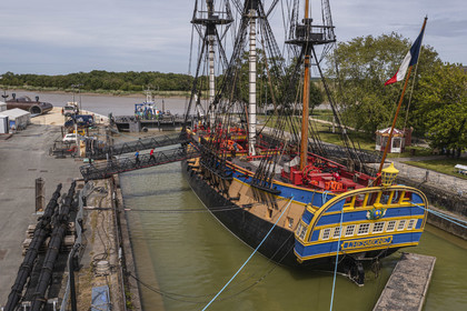 France, Charente-Maritime, Rochefort, International Center of the Sea in the former Rochefort Maritime Dock, the frigate Hermione in the dry dock, it's the replica of the three-master ship where the Marquis de Lafayette sailed for America in 1780 (aerial view)