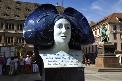 France, Bas Rhin, Strasbourg, old town listed as World Heritage by UNESCO, Place Gutenberg, Street Heart, traveling exhibition of 10 giant carvings of Alsatian headdresses scattered throughout the city, statue of Gutenberg in the background