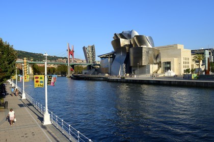 Spain, Basque Country Region, Vizcaya Province, Bilbao, the Guggenheim Museum designed by Frank Gehry and the Salve bridge with Les Arches Rouges artpiece by French artist Daniel Buren in the background