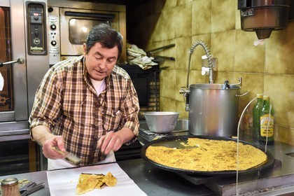 Principality of Monaco, Monaco, Condamine Market, Roger cutting socca parts in his shop