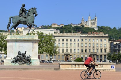 France, Rhone, Lyon, historical site listed as World Heritage by UNESCO, equestrian statue of louis XIV on place Bellecour and Notre Dame de Fourviere in the background