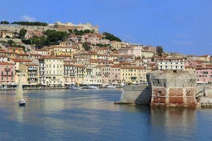 Italy, Tuscany, Elba Island, Portoferraio overlooked by the Medici fortifications and the Torre del Martello Tower at the entrance of the port