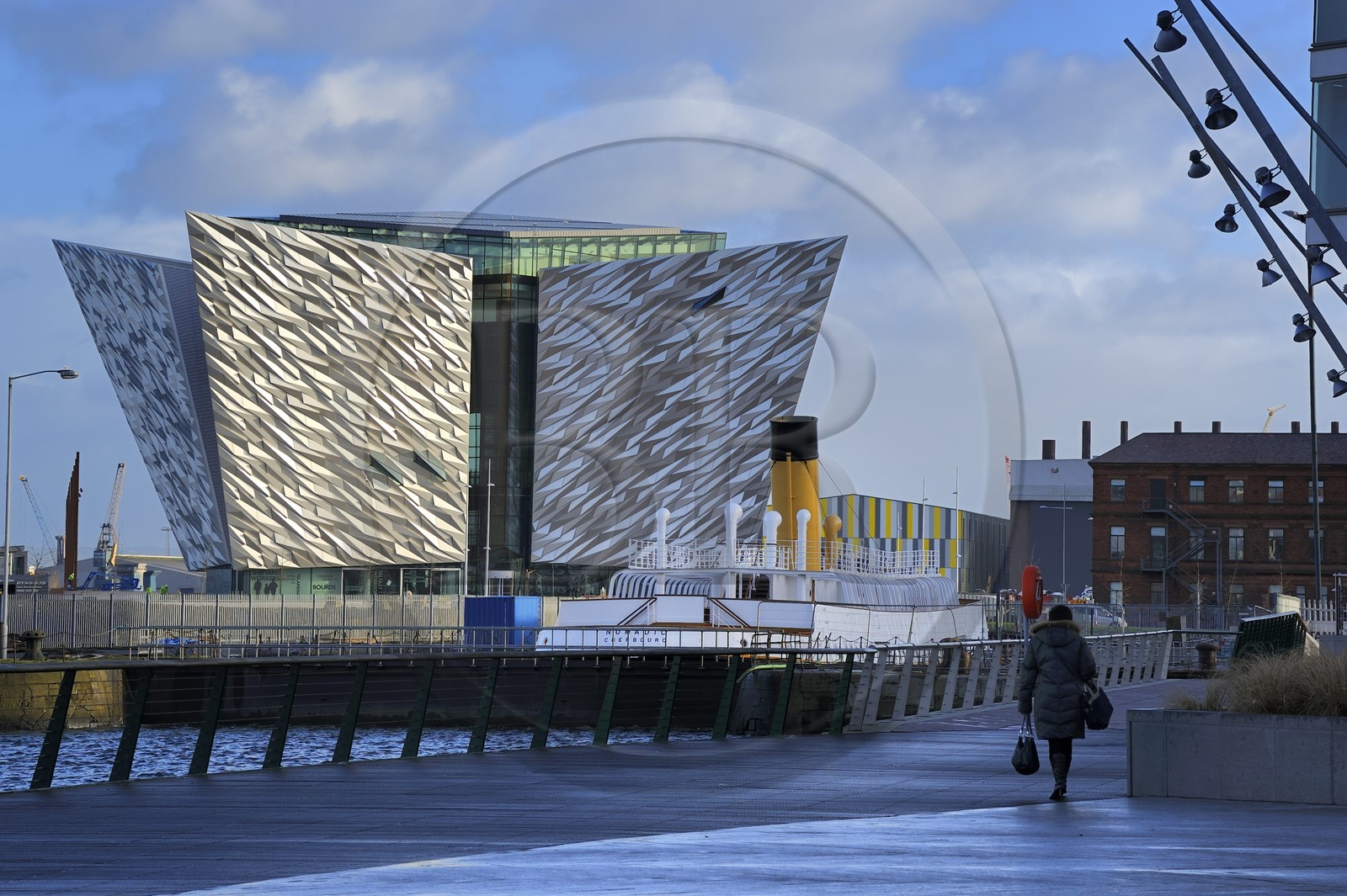 United Kingdom, Northern Ireland, Belfast, the new Titanic Quarter of Queen's Island, the SS Nomadic of the White Star Line built as a tender to the liners RMS Olympic and RMS Titanic, and the Titanic Belfast Experience center in the background