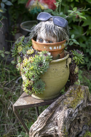 France, Nièvre, La Collancelle, composition with doll's head in the garden of a lock keeper's house