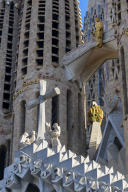 Spain, Catalonia, Barcelona, Eixample district, Sagrada Familia basilica by Catalan modernist architect Antoni Gaudi, listed as a UNESCO World Heritage Site, the passion facade, the Glorious Cross under the bronze sculpture of the ascension of Christ