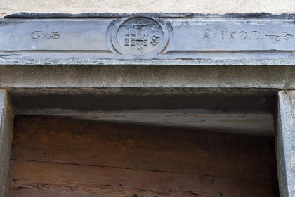 France, Alpes-Maritimes, Roya Valley (Nice hinterland), at the foot of the Mercantour National Park, Tende, green slate lintel engraved with the monogram IHS meaning Jesus savior of men that keeps evil spirits away from the house