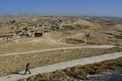 Israel, West Bank, Herodium or Herodion is a volcano-like hill with a truncated cone with a a fortress and palace build by Herod the Great (Herodion National Park), remains of the palace of the lower Herodium and its basin, in the distance Bethlehem