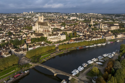 France, Yonne, Auxerre, Saint Etienne Cathedral and Saint Germain Abbey on the right, the Green belt cycle path along the Yonne on the quay facing the port, the barge La Scène des Quais moored at the foot of the Passerelle de la Liberté in the foreground (aerial view)