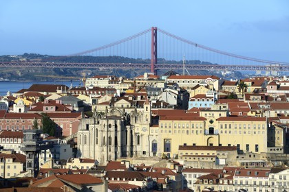 Portugal, Lisbon, the Gothic ruins of Carmo 15th century church partly destroyed by 1755 earthquake, Bairro Alto district and the 25 de Abril bridge on Tagus river in the background
