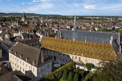 France, Cote d'Or, Beaune, area listed as World Heritage by UNESCO, Hospices de Beaune, Hotel Dieu, the Notre-Dame de Beaune collegiate basilica in the background (aerial view)