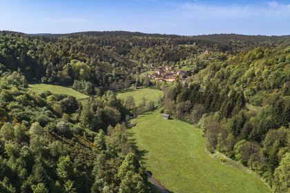 France, Lozere, Cheylard-l'Evêque, hiking with a donkey on the Stevenson trail (GR 70), the village in the valley (aerial view)