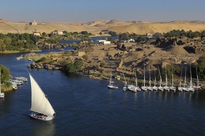 Egypt, Upper Egypt, Nubia, Nile Valley, Aswan, Elephantine Island on the right with archeological excavations site of Satis and Khnoum temples and the Agha Khan mausoleum in the background on the western bank
