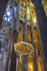 Spain, Catalonia, Barcelona, Eixample district, Sagrada Familia basilica by Catalan modernist architect Antoni Gaudi, listed as a UNESCO World Heritage Site, the presbyterium, a choir reserved for the clergy, surmounted by the crucified Christ hanging from a suspended canopy