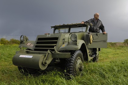 France, Calvados, Caen, Jean Pierre Benamou, president of D-Day Academy guiding visitors on the Normandy landing sites : here a white scout car M3A1