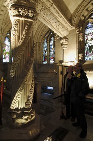 United Kingdom, Scotland, Midlothian, Roslin, Rosslyn Chapel, visitors dissecting the symbolism of the sculptures of the the Apprentice Column