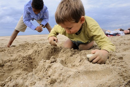 France, Calvados, Pays d'Auge, Deauville, kids playing on the sandy beach