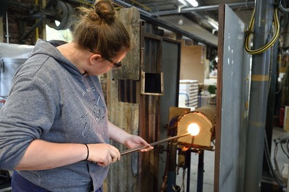 France, Moselle, Meisenthal, Centre international d'Art verrier (CIAV) (international glass centre), the blowing workshop, crafting a Christmas ball, the blower collects a mass of molten glass from the furnace, with his glassmaker's cane