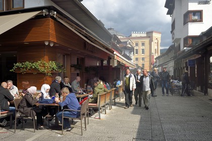 Bosnia and Herzegovina, Sarajevo, Bascarsija district in the old town, Bravadziluk street famous for its Burek and cevapi, the National and University Library in the backgroundrestaurants