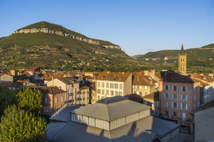 France, Aveyron, Millau, the market hall built in 1899 in the heart of the city center, the Notre-Dame de l'Espinasse church and the Puncho d'Agast mountain in the background