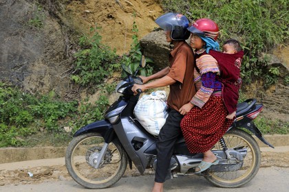 Vietnam, Lao Cai province, Bac Ha district, Can Cau, family from the Flower Hmong minority group on a motorbike