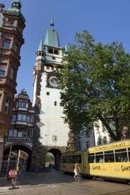 Germany, Baden-Wurttemberg, Freiburg im Breisgau, tram on the street Kaiser-Joseph Strasse and the Martinstor one of the original city gates in the background