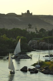 Egypt, Upper Egypt, Nubia, Nile Valley, Aswan, the Agha Khan mausoleum on the western bank dominating the first cataract and feluccas