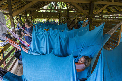 France, French Guiana, Kourou, the carbet (shelter) at Camp Maripas on the banks of the Kourou river, hammocks suspended under the rafters