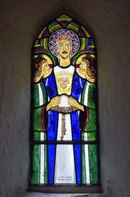 France, Cantal, Sainte-Marie, Sainte-Agathe church, stained glass window designed by Jean Cocteau and made in Saint Jean Cap Ferrat in the Pelissier workshops, Christ surrounded by two angels whose indexes meet represents a Sacred Heart