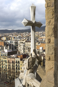 Spain, Catalonia, Barcelona, Eixample district, Sagrada Familia basilica by Catalan modernist architect Antoni Gaudi, listed as a UNESCO World Heritage Site, the Cross at the top of the passion facade whose sculptures were made by Josep Maria Subirachs