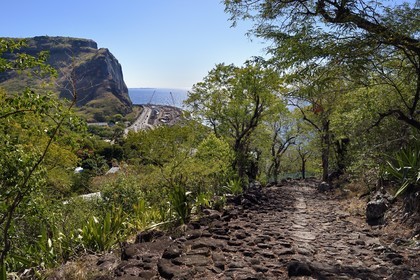 France, Reunion island (French overseas department), La Possession, la Grande Chaloupe valley, chemin Cremont also called chemin des Anglais, an old road paved with basalt since 1775, the coastal route of the 20th century and the construction site of the New Littoral Route (NRL) of the 21st century in the background