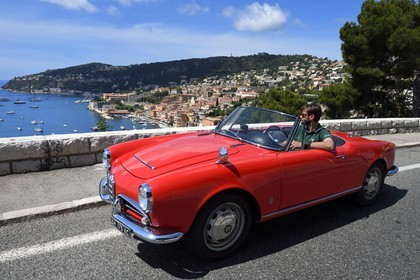 France, Alpes-Maritimes, Villefranche-sur-Mer, collection convertible Alfa Romeo Giulietta on the Basse Corniche road overlooking the city