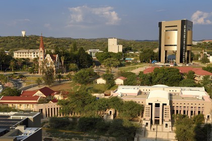 Namibia, Khomas region, Windhoek, Christ Church (or Christuskirche), Lutheran church designed by architect Gottlieb Redecker, the Independence Memorial Museum built by North Korea and the Supreme Court in the foreground