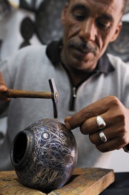 Morocco, Meknes Tafilalet Region, Meknes, Imperial City, medina listed as World Heritage by UNESCO, craftsman making damascening with silver