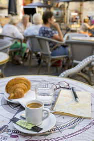 France, Cote d'Or, Dijon, area listed as World Heritage by UNESCO, place Rude, coffee and croissant on a table on the terrace of a bistro